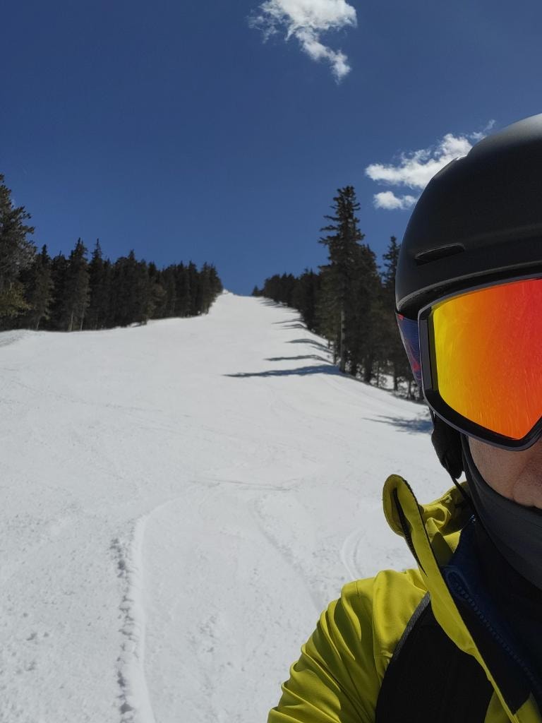 First One Down — skier on an empty mountain slope
