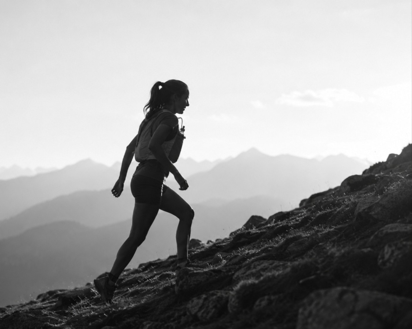 Hiker on trail wearing a hydration vest